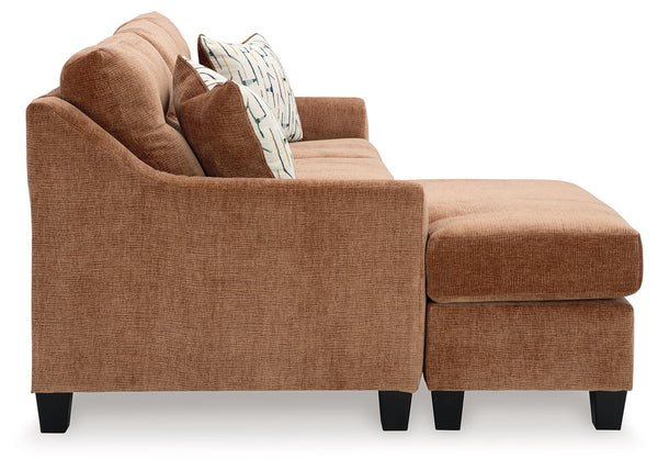  finesses the piece with just the right touch. Gently flared arms and tufted back cushion