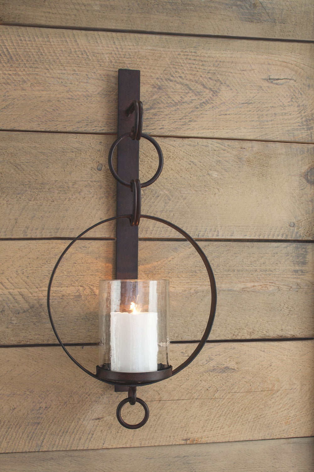 Hang out in style. Bring warmth and flair to an overlooked space with this wall sconce and candle holder. Dark bronze-tone metal and clear glass make a striking combination. Aligned or staggered, theyâ€™re even more beautiful when paired.<br><br><b>Additi