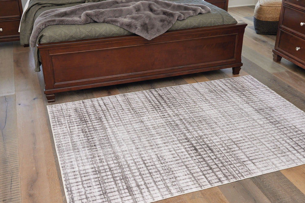 Who says art has to be limited to your walls? This eye-catching area rug adds gallery-worthy fashion to your floors. Visually rich with a cream and taupe geometric design, it takes center stage and adds a dash of distinction to your home. The engaging pat