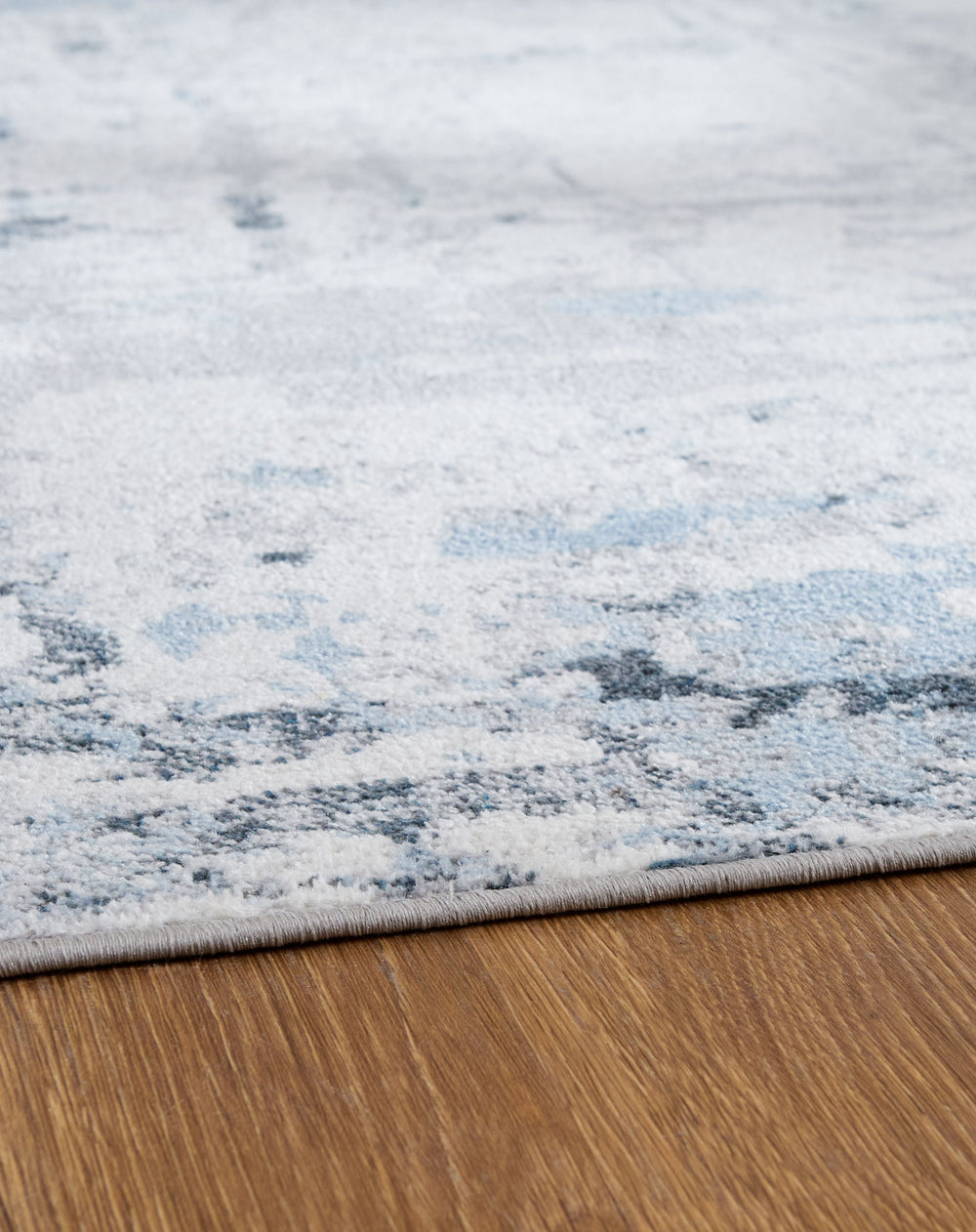 This area rug makes the ultimate statement for an effortlessly chic sense of style. Abstract patterns in blue, gray and white dance across this plush floor covering, creating a pleasing design that-'s sure to elevate any modern home. And when your rug nee