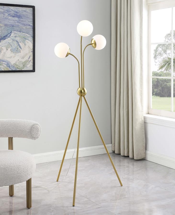 A trio of milky white globes sprout from the center of a charming mid-century modern three-light floor lamp. Delivering a warm, diffused glow in your living area or bedroom, the eye-catching lamp features a bold tripod base with a round accent from which 