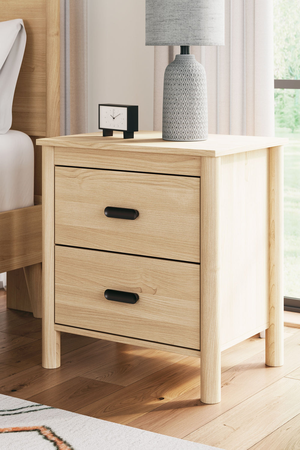 This nightstand brings on-trend style and a sense of serenity to the bedroom. Invitingly simple, its spacious drawers give you plenty of space to store your bedside essentials. Best of all, the natural wood finish and relaxed warmth complement any interio