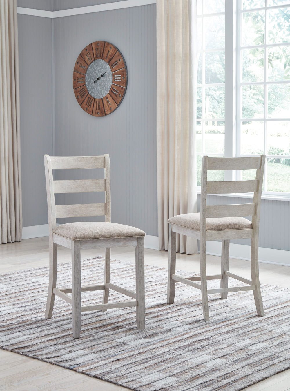 This upholstered bar stool invites you to raise the bar on small space living. An inspired choice for coastal chic or modern farmhouse settings, this comfortably cushioned bar stool with classic ladderback styling sports a grayish white finish with rub th