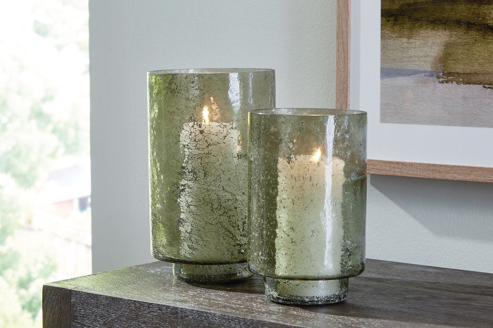 Create an even cozier ambiance in your home with this candle holder set. Their green sanded glass makes the soft glow of electric or real candles all the more beautiful. Stunning when displayed as a duo or standing alone, these holders are a simple way to