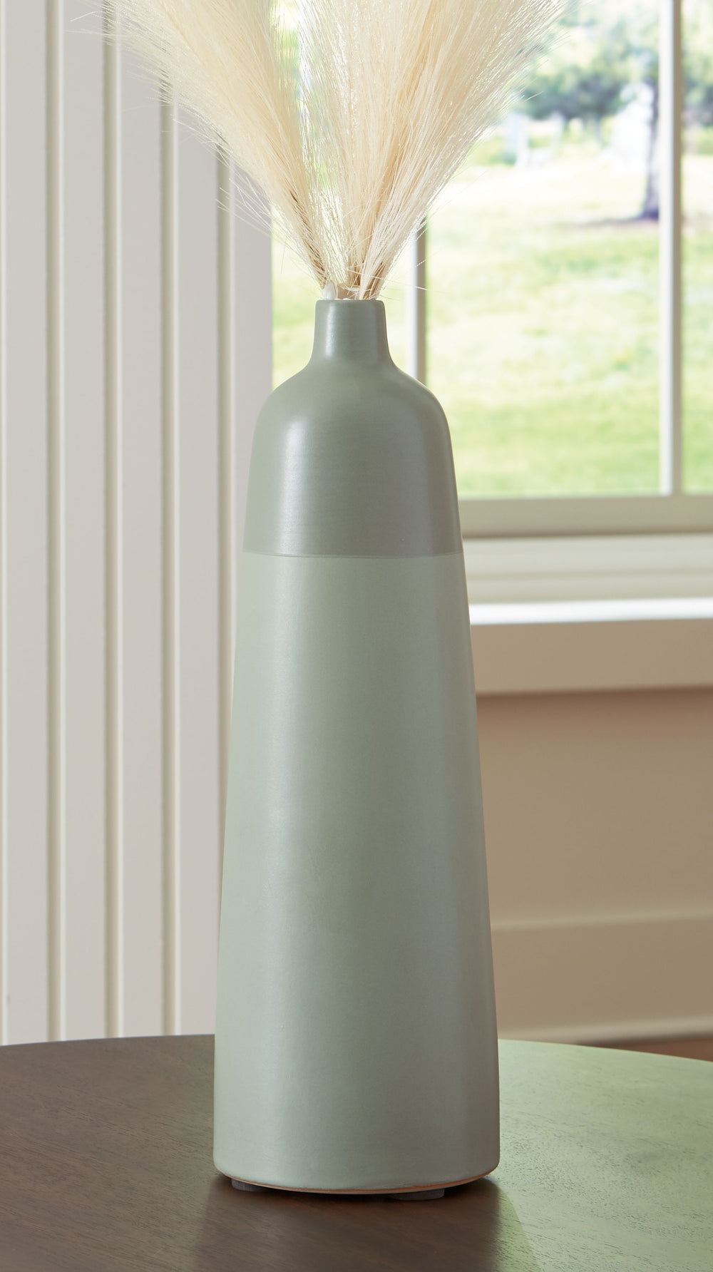 This richly glazed ceramic vase makes a striking centerpiece, either by itself or filled with dried or faux florals. Its simply beautiful shape and organic green hues complement your naturally superb sense of style.<br/><br/><b>Product Features</b><ul><li