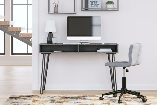  this home office desk is casual contemporary at its finest. The desktop is wrapped in a replicated dark charcoal gray wood grain and paired with decidedly mid-century style black legs for a familiar-yet-fresh design. A