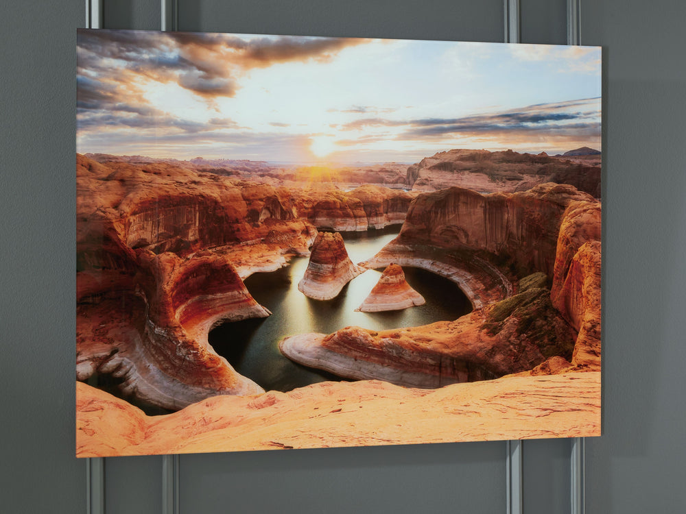 Immerse yourself in the breathtaking beauty of this print on glass. Capturing the serene majesty of sunrise over intricate canyon rock formations and tranquil waters, it brings the awe-inspiring wonders of nature into your home. This stunning piece adds a