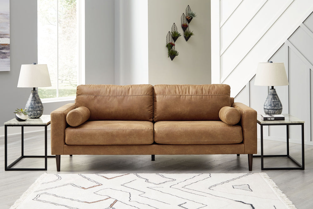  tailored to perfection. This sofa echoes retro aesthetics with warm caramel faux leather
