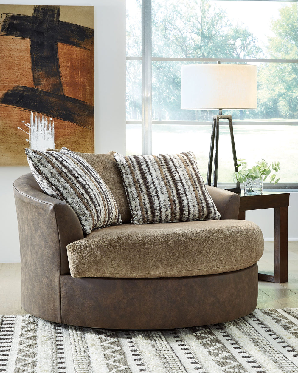 This oversized swivel accent chair is perfect for those who love the look of leather. Two textural tones provide twice the style and comfortâ€”and incorporate an added layer of visual interest. By allowing you to swivel, this chair marries the best of for