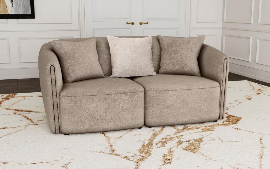Augment living room seating with the inviting profile of a modern loveseat. Its curved shelter back and sloping arms establish a refined look and feel, while tailored upholstery offers curated appeal. The loveseat is upholstered in chenille with a neutral