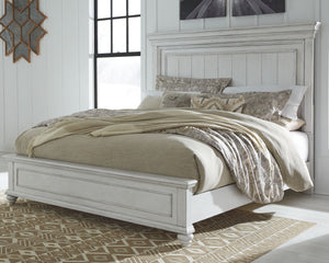 Give your retreat vintage charm with this California king panel bed. In a beautifully distressed whitewash finish, you-'ll love the headboard-'s grand style featuring a picture framed panel. Generously scaled moulding from top to bottom, along with bun fe