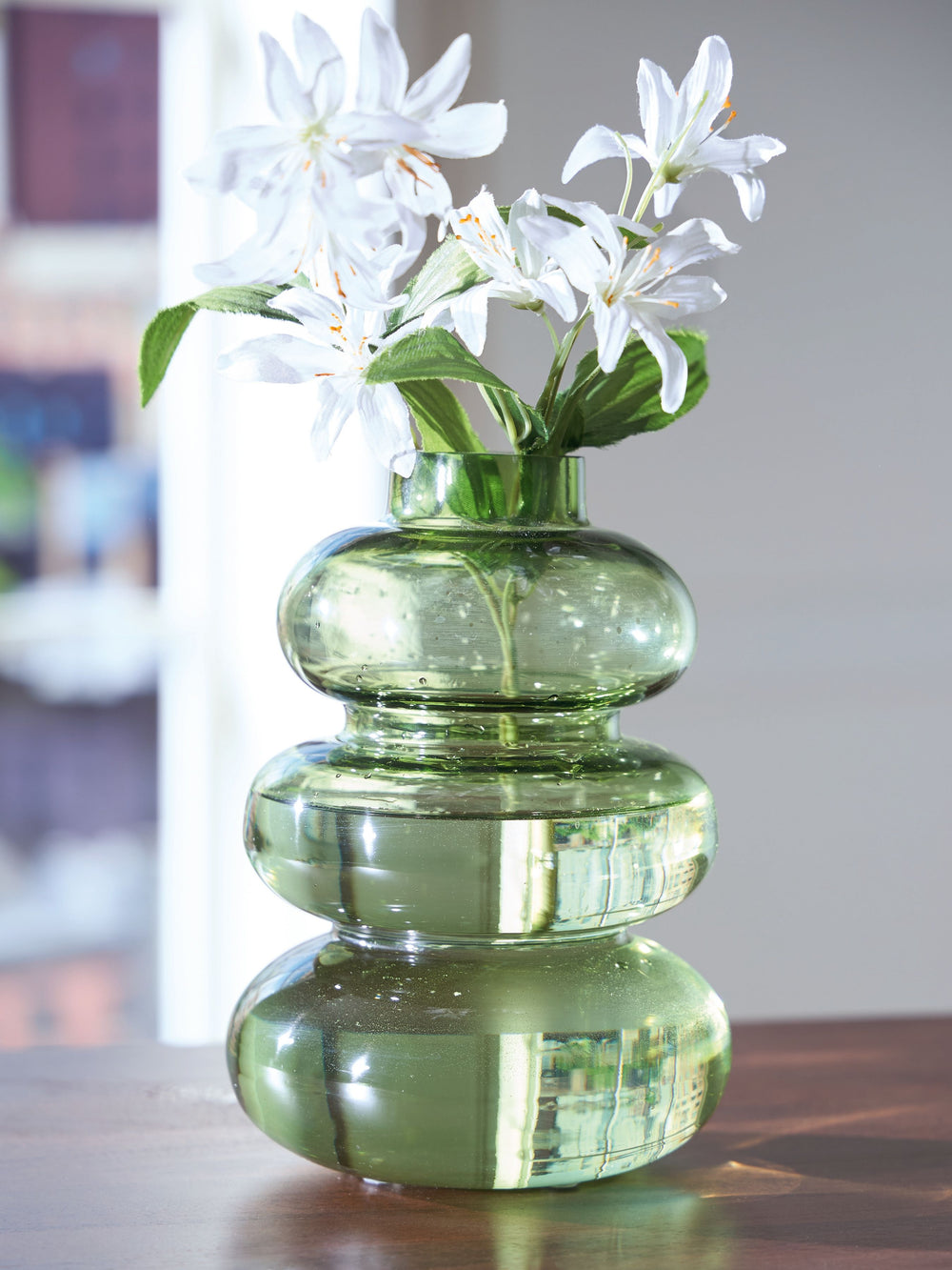 Give your living space a modern vibe. This vase is beautifully crafted from blown glass, with rounded organic shapes that provide plenty of visual interest. Add a single dried bloom or faux greenery to accentuate its simple splendor.<br/><br/><b>Product F