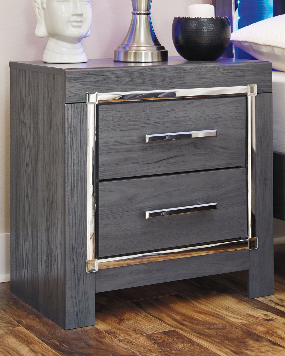 Reminiscent of Hollywood glamour of yesteryear, this nightstand interprets luxury in a decidedly modern way. A dazzling gray finish with faceted chrome-tone accents enhance the star power, while two smooth-gliding drawers provide convenient bedside storag