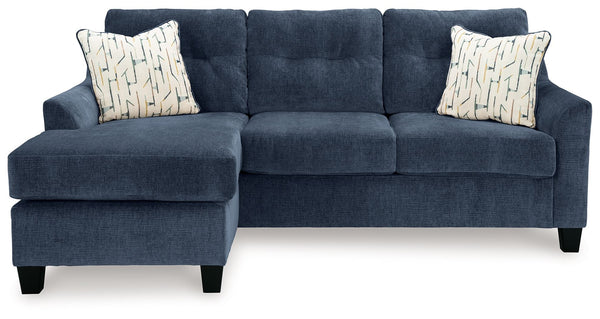  finesses the piece with just the right touch. Gently flared arms and tufted back cushion