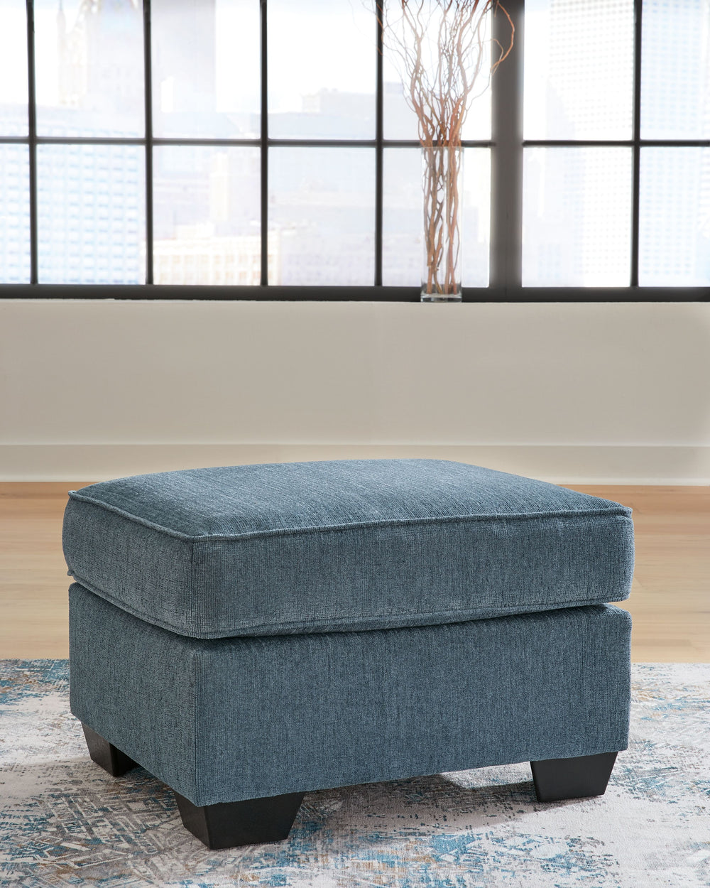 Need a simple style refresh? Liven up your living room essentials with this ottoman. A chunky silhouette holds inviting cushioning perfect for propping up feet or a decorative tray. Crosshatched upholstery gives the otherwise casual design a delightful vi