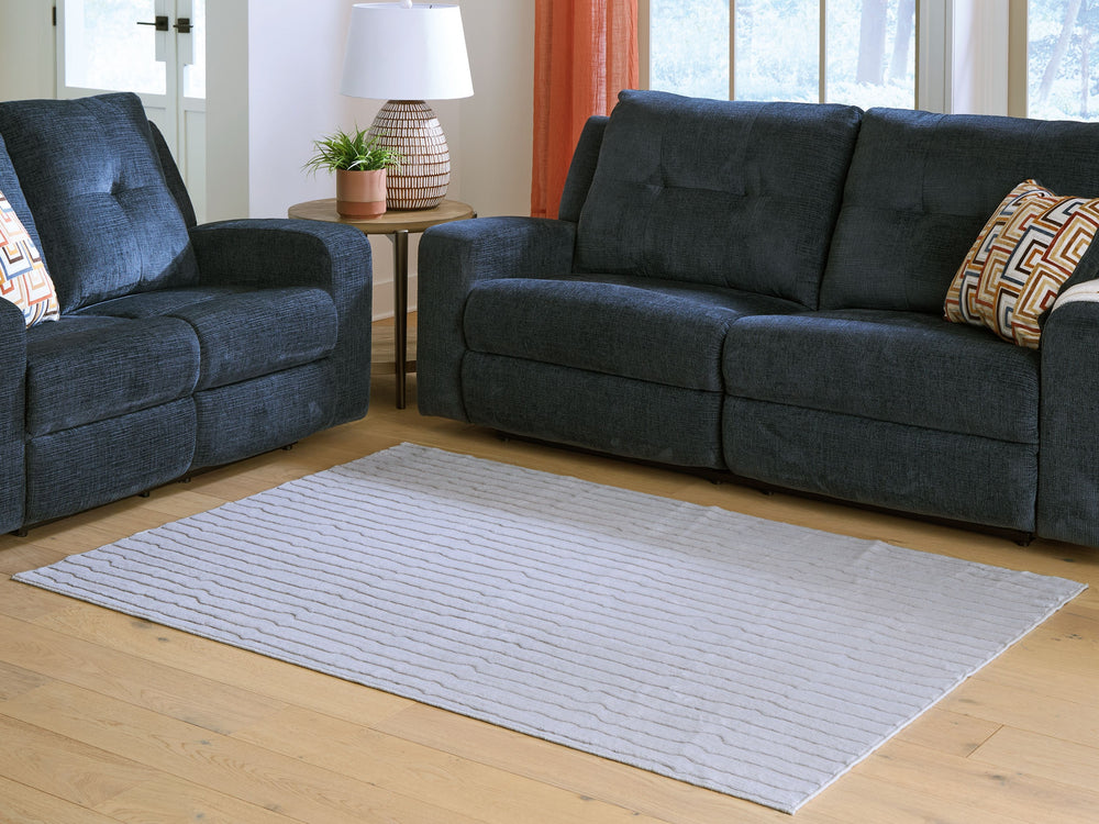 Impress with contemporary cool character. This rug welcomes visitors with subtle stripes and soft faux fur underfoot, while its neutral gray is an understated way to dress up your floor. Plus it-'s machine washable for fuss-free cleaning.<br/><br/><b>Prod