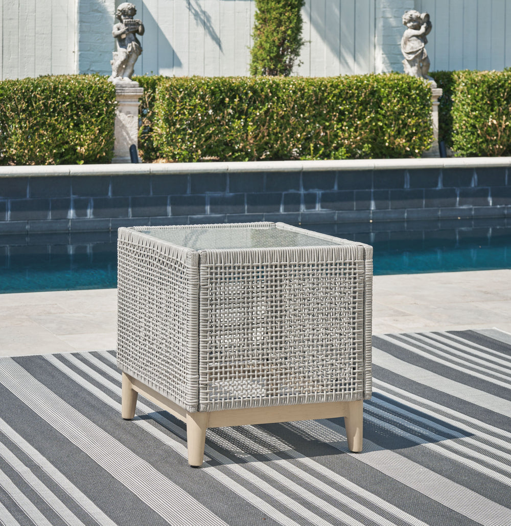 This end table invites your casual contemporary style outdoors. With its resin wicker in a chic neutral hue, it expertly marries refined design with durability. Breezy summer mornings and cold winter nights are made all the more enjoyable with a glass tab