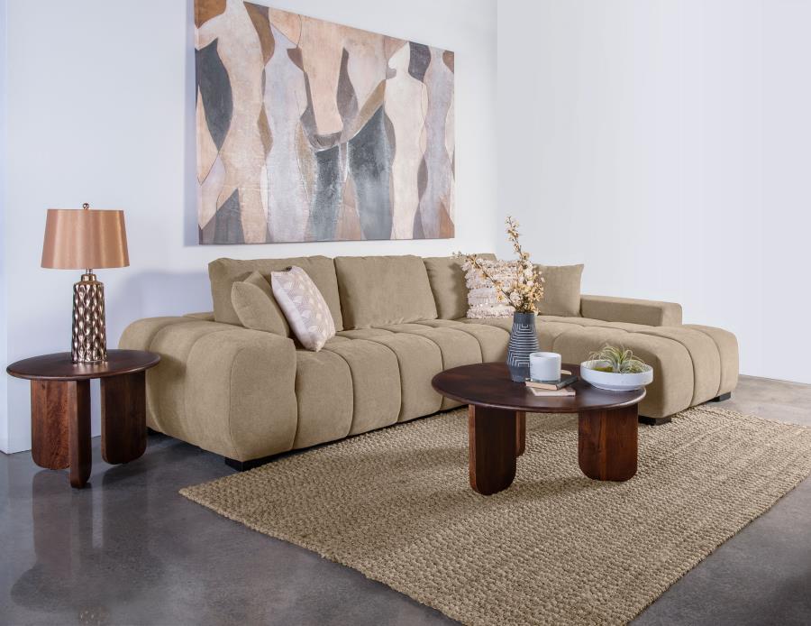 Embrace comfort and timeless style with this mid-century inspired sectional sofa. Designed for relaxed lounging, it showcases wide, rounded arms and plush waterfall seat cushions adorned with subtle grid tufting. Soft, neutral upholstery envelops a sturdy