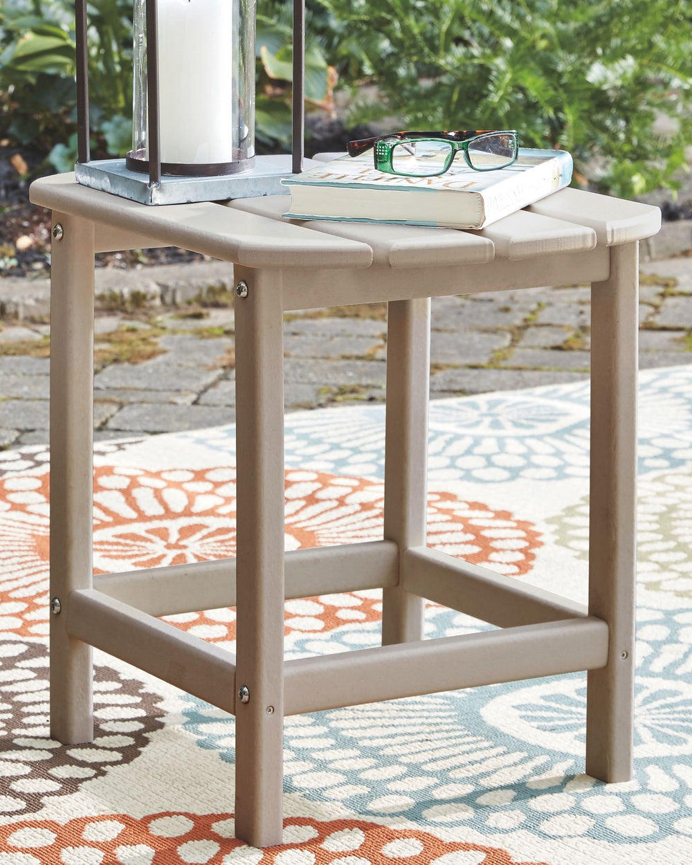 Add cottage-quaint charm to your outdoor oasis with this outdoor end table in a driftwood finish. Made of MEGA-TUFFÂ® high-density polyethylene material, itâ€™s sure to weather the seasons beautifully. Designed to shed rainwater, the tableâ€™s slatted top