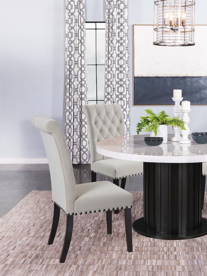 Blending timeless elegance with plush comfort, this side chair enhances any dining space. Its high backrest features a classic button-tufted design, adding depth and sophistication. A rolled top and hand-applied nailhead trim create refined detailing, whi