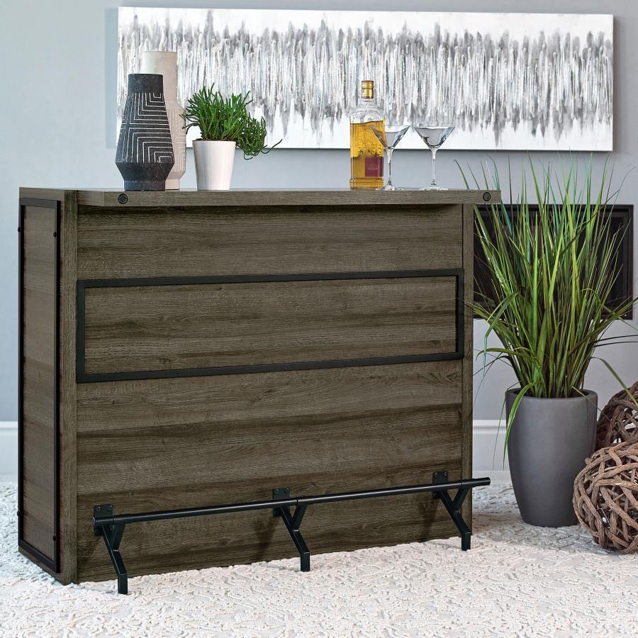 Serve up smile after smile at your next gathering of guests. This handsome, wooden bar unit boasts a bold, rustic design to enliven your space. Five roomy shelves with stemware racks provide plenty of space for your party essentials. A metal footrest is a