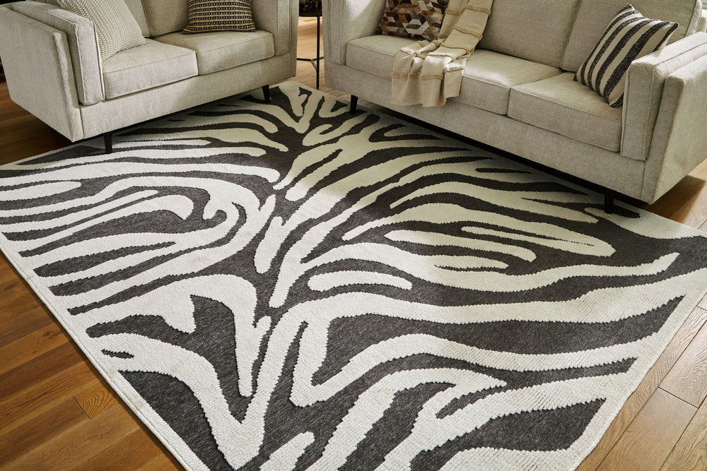 Cover your floor in safari vibes. A bold zebra design on this area rug brings a bit of rugged chic to any room. Machine washable for easy maintenance, the contemporary statement piece knows no boundaries.<br/><br/><b>Product Features</b><ul><li>Made of po