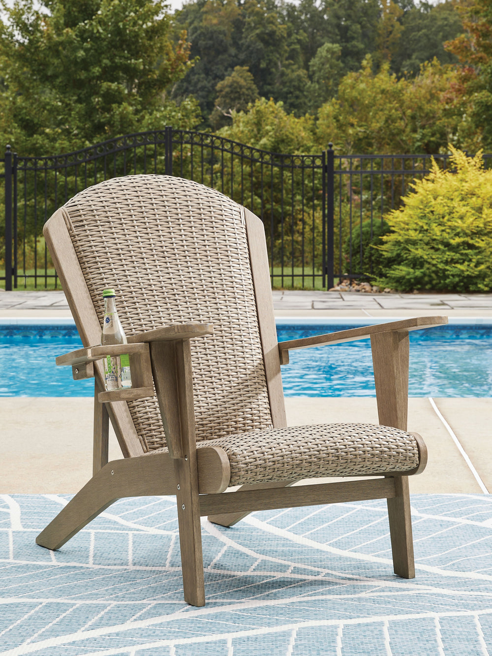 This Adirondack chair takes a classic design to new heights of relaxation. Comfortably padded and crafted with durable eucalyptus wood and handwoven resin wicker, this chair weathers the seasons beautifully with exceptional form and function.<br><br><b>Ad