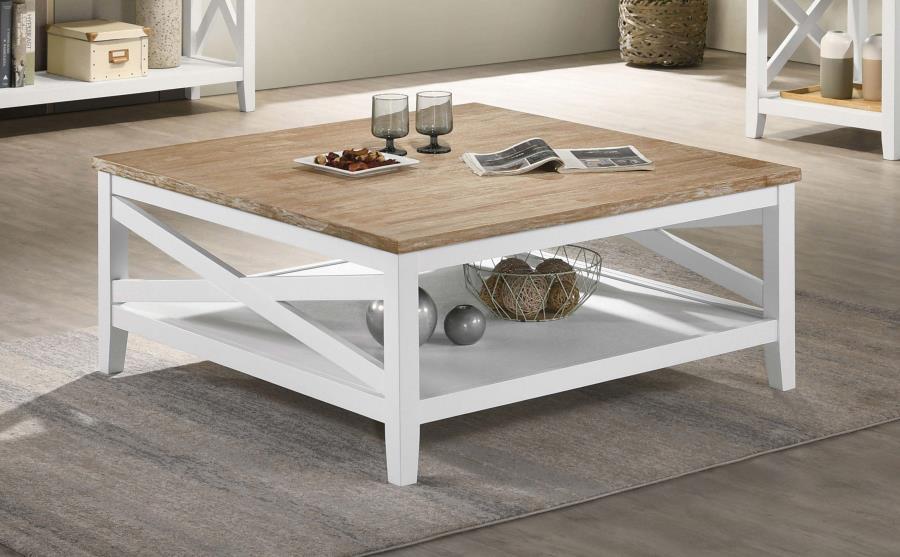 A square silhouette established a welcoming look and feel for a farmhouse coffee table. Great for family spaces, the cocktail table lends casual elegance with style that complements cottage, coastal and relaxed sitting areas. Its table top is wire brushed