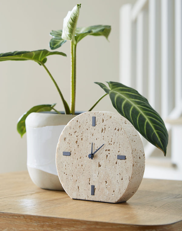  this clock is sure to lend minimalist flair to shelves and tabletops. Black accents provide a dramatic contrast to the earthy sensibility of the simple-yet-sophisticated timepiece