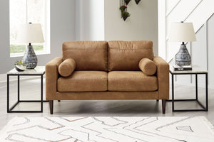  tailored to perfection. This loveseat echoes retro aesthetics with warm caramel faux leather