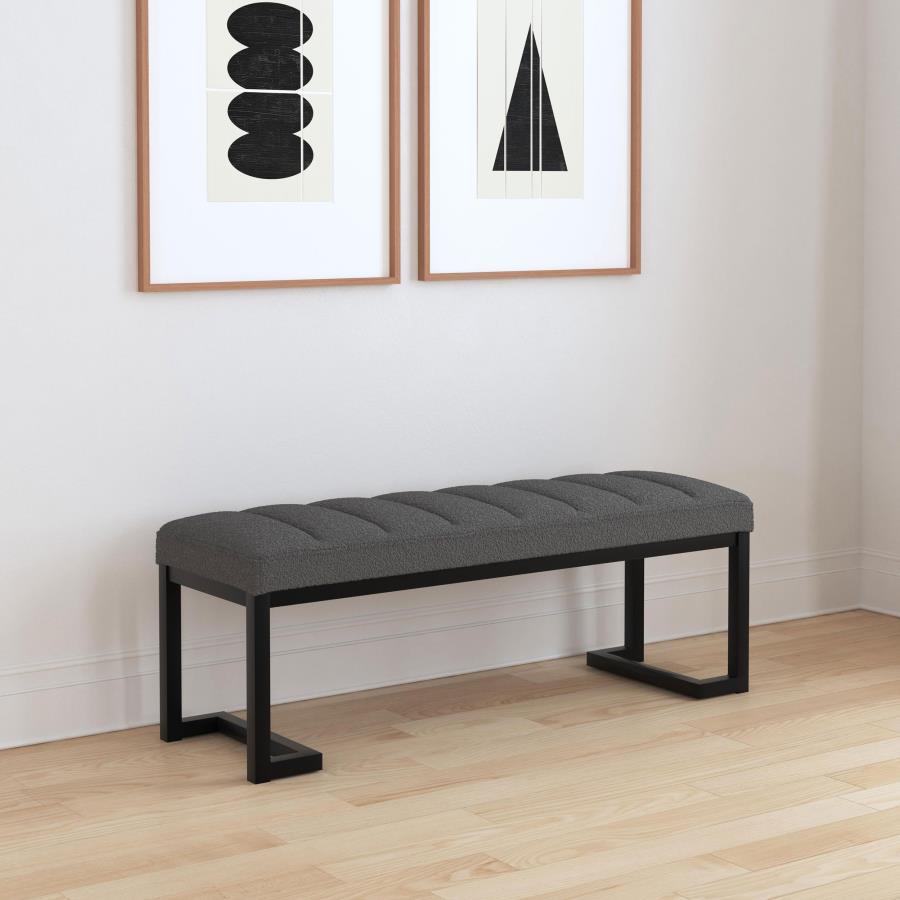 Textured upholstery plays perfectly with the modern silhouette of a backless accent bench. Its deep black finished frame is constructed in metal for excellent durability, with a bracket inspired silhouette that emphasizes its contemporary design credentia