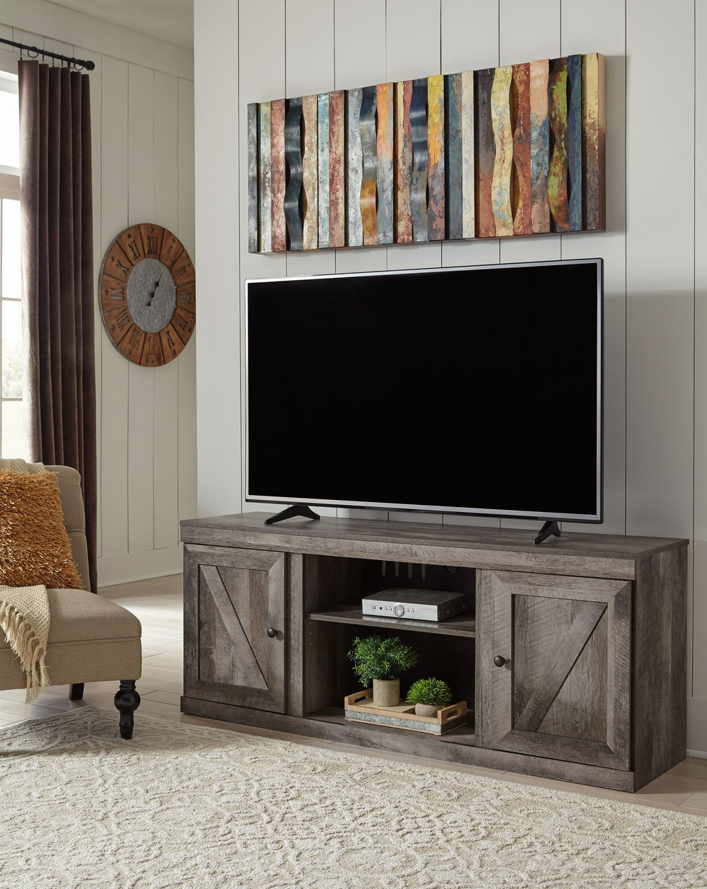This TV stand is sure to win your heart with its daring take on modern rustic design. Its crisp, clean minimalist-chic profile is enriched with a striking replicated oak grain, thick plank styling and a rustic gray finish for that much more authentic char