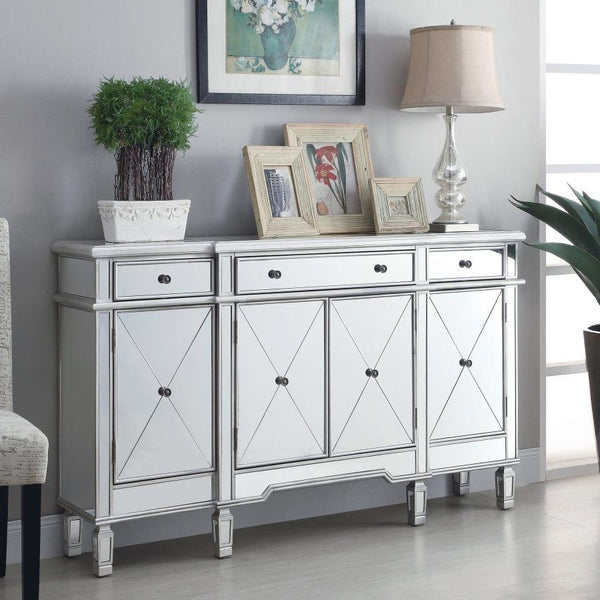  the cabinet features four doors with beveled mirrored panels and three top drawers for added storage. Inside