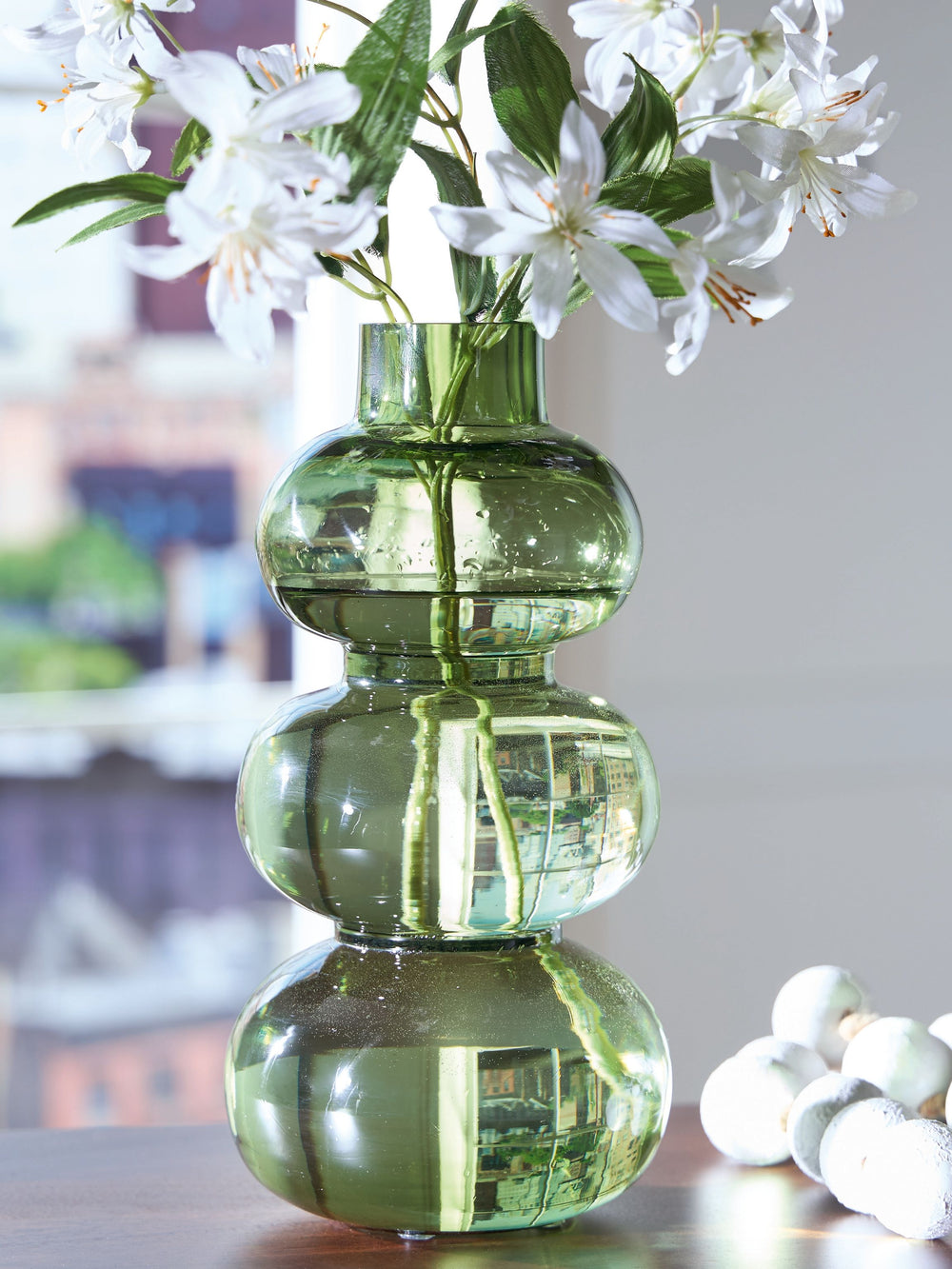 Give your living space a modern vibe. This vase is beautifully crafted from blown glass, with rounded organic shapes that provide plenty of visual interest. Add a single dried bloom or faux greenery to accentuate its simple splendor.<br/><br/><b>Product F