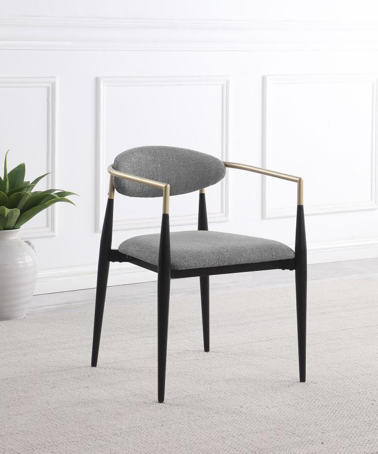 Refresh your dining table with the modern glam flair of a set of two armchairs. Perfect for family and friends, the chair offers impeccable comfort with a padded seat and an oval-shaped backrest with a gentle curvature for excellent support. Its metal fra