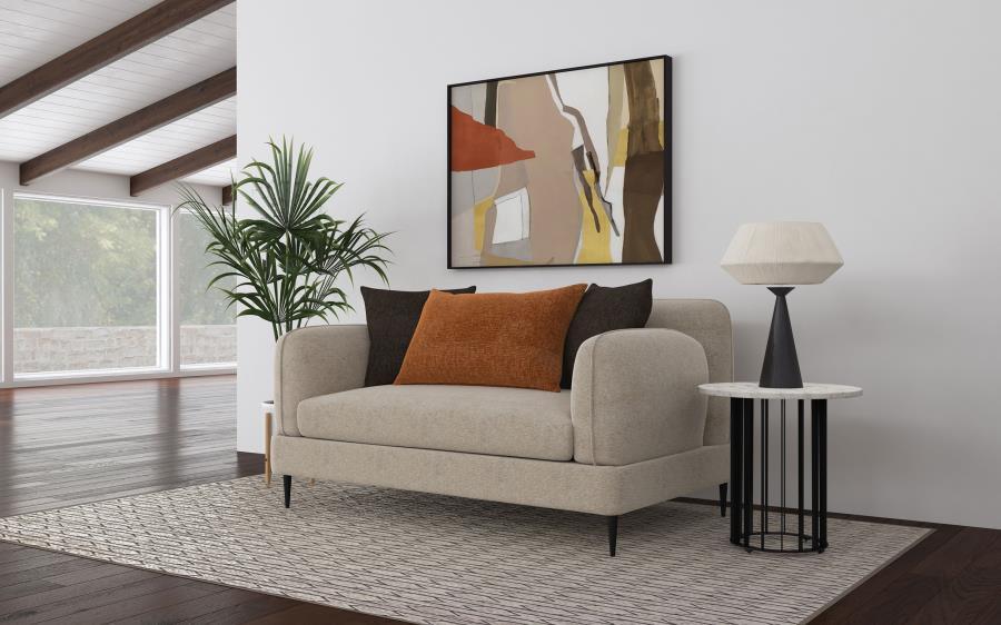 The loveseat blends chic architectural elements with cozy sophistication, wrapped in latte chenille upholstery for a soft, textured feel. Its rounded, sculpted track arms and matching back provide a harmonious design, accented by a sleek waterfall bench s