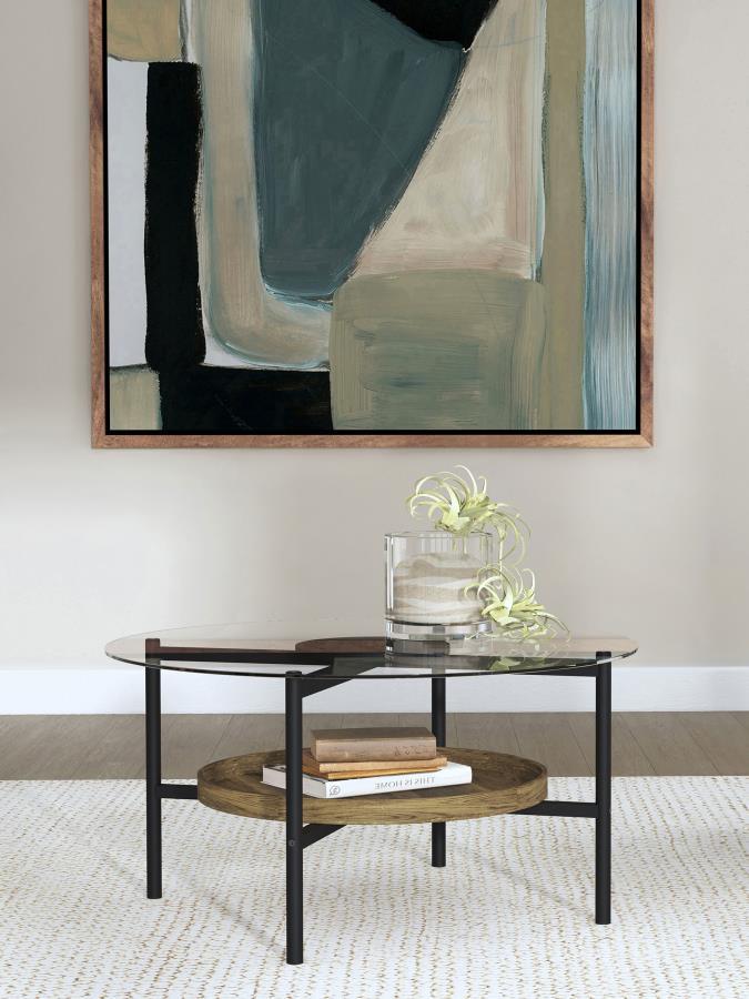 Center your living space with this inviting transitional coffee table that combines farmhouse charm with modern elegance. The X-cross frame is exposed beneath the round tempered glass top, adding dimension and visual interest. A black finish disc at the i