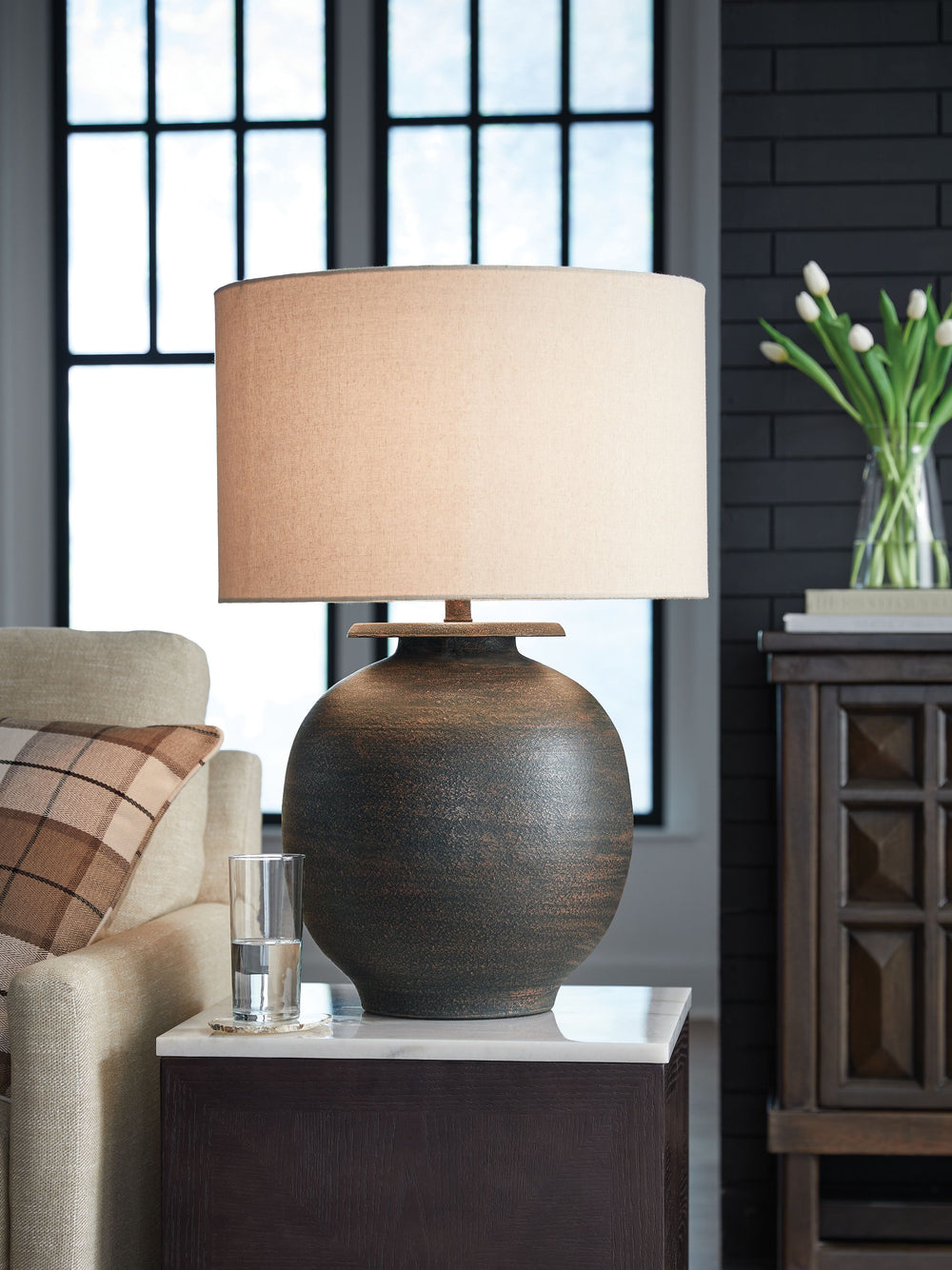 Brighten up your space with the casual, earthy elegance of this lamp. Outfitted in an antiqued brown hue, its simple curved form ushers in an air of effortless beauty when placed on an accent table or desk.<br><br><b>Additional Dimensions</b><br><ul><li>S