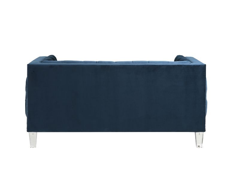 Sophistication meets modern with the Ansario living room collection. The rich blue velvet adds character to any room. Showcasing a square back, high arms, and nail-head trim, feature button tufted accents. The acrylic legs give off a modern vibe to the pi