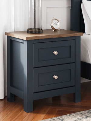  this nightstand pairs a dark slate blue finish with a light brown top. Drawer fronts and legs in a classic Shaker style bring an air of beautiful simplicity to the bedroom