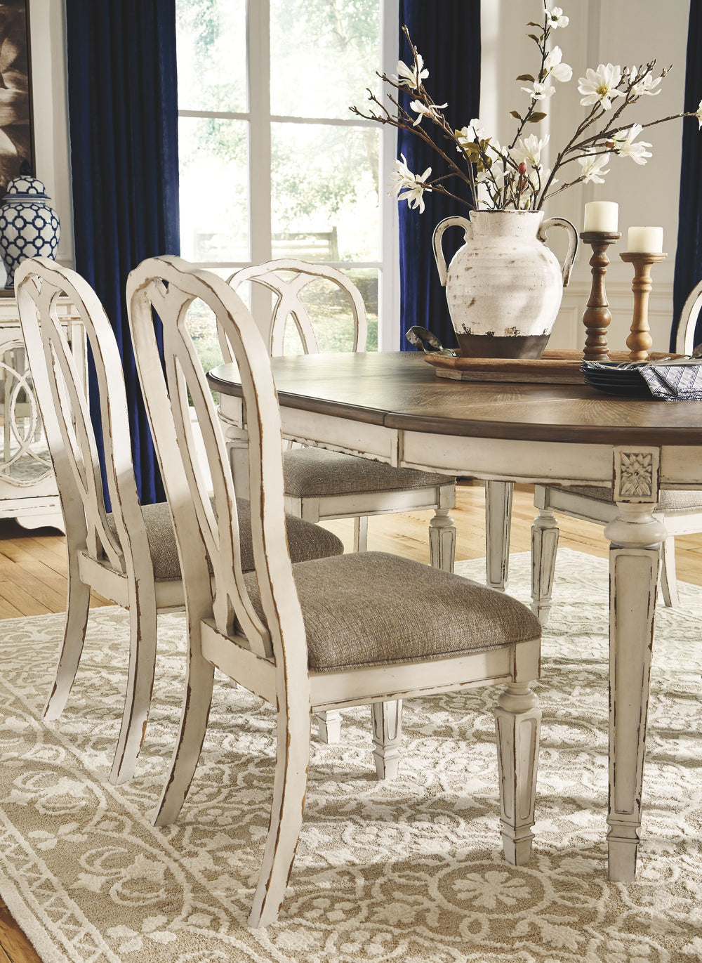 Traditional cottage design. Antiqued two-tone finish featuring chipped white with distressed wood finished tops. Tops feature Oak veneers, while the cases are made with birch veneers and hardwood solids. Framed drawer fronts and decorative fret laid over 