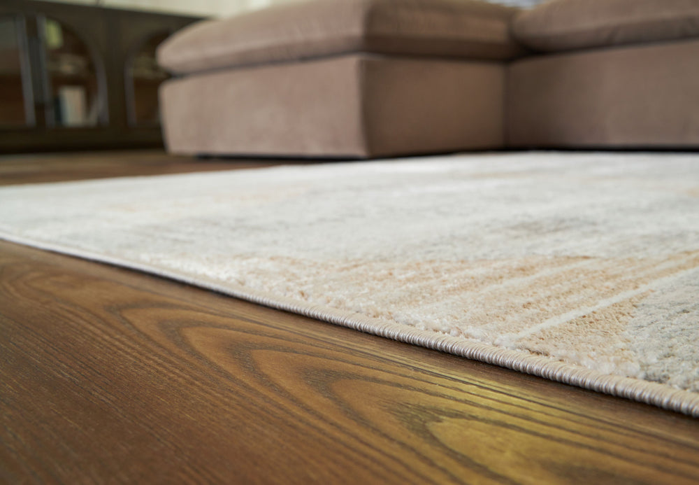 This abstract rug is crafted to captivate. Its interplay of linen, gray and caramel hues creates a chic masterpiece suited to both modern minimalist and warm traditional aesthetics. With its chic character, this rug anchors your space with sophistication 