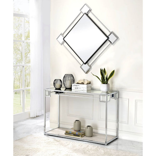  the metal frame is finished with a mirrored trim along with a geometric pa
