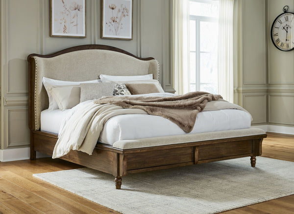  inviting and beautifully in the moment. Case in point: this queen upholstered panel bed. The alluring piece features a distinctive headboard with a shelter wing design. Its cushioned bench f