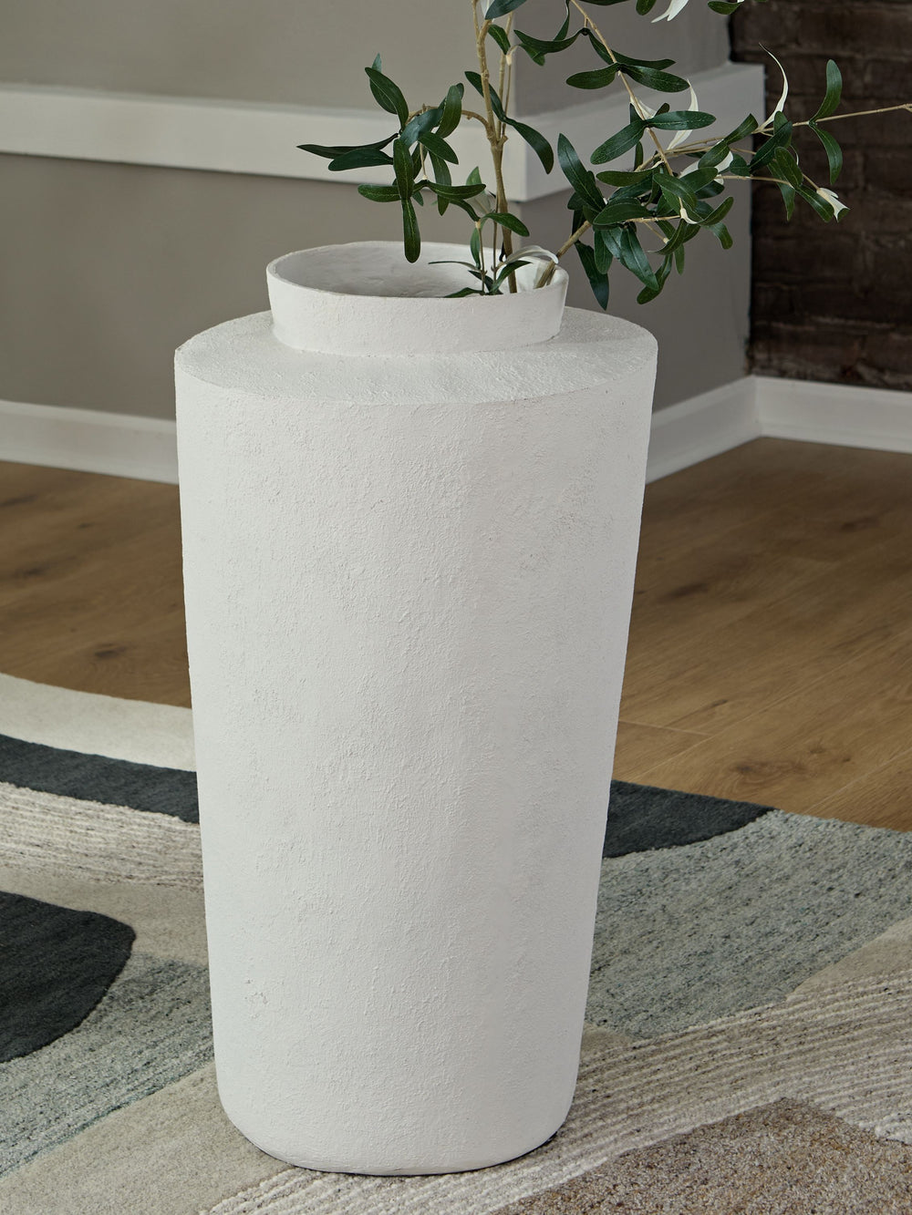 Simply chic. With its textured pattern and asymmetrical top, this cream-colored floor vase is a subtly stylish addition to your decor. Refresh the look by switching out your favorite faux floral arrangements from season to season.<br/><br/><b>Product Feat