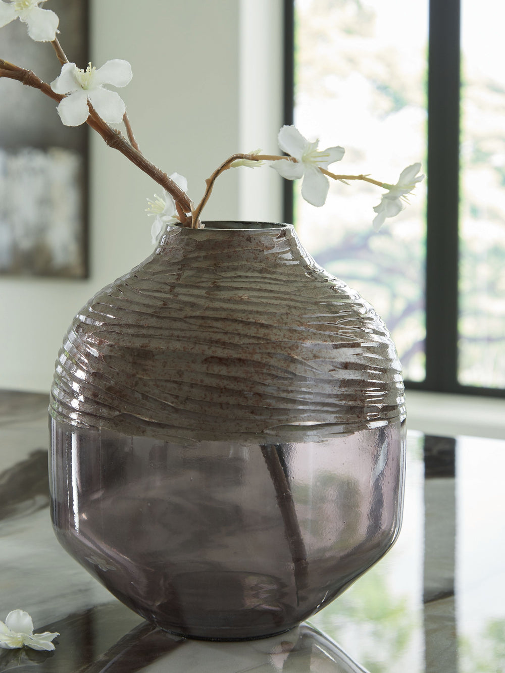 The accent is on contemporary with this exquisite glass vase. Its cool iridescent gray finish and hand-carved pattern deliver a sophisticated statement wherever you like. For those with an artful eye and a love of modern elegance, it-'s a beauty to behold