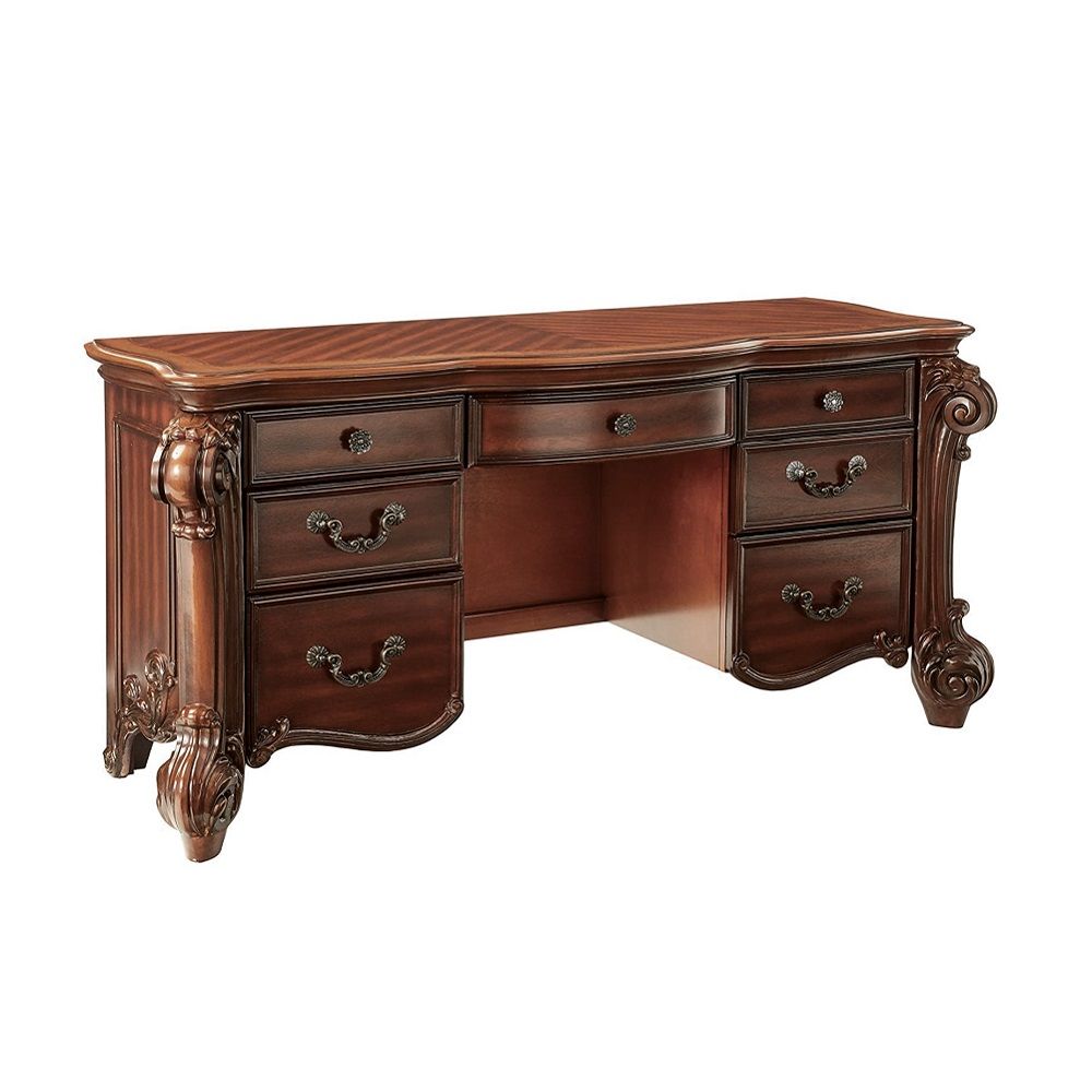 Create an elegant, traditional design in your bedroom with the cherry Vendome vanity desk. This hand-crafted piece inspired from the luxurious designs of the past, this seven-drawer, desk features elaborate wood carving details, traditional hardware and a
