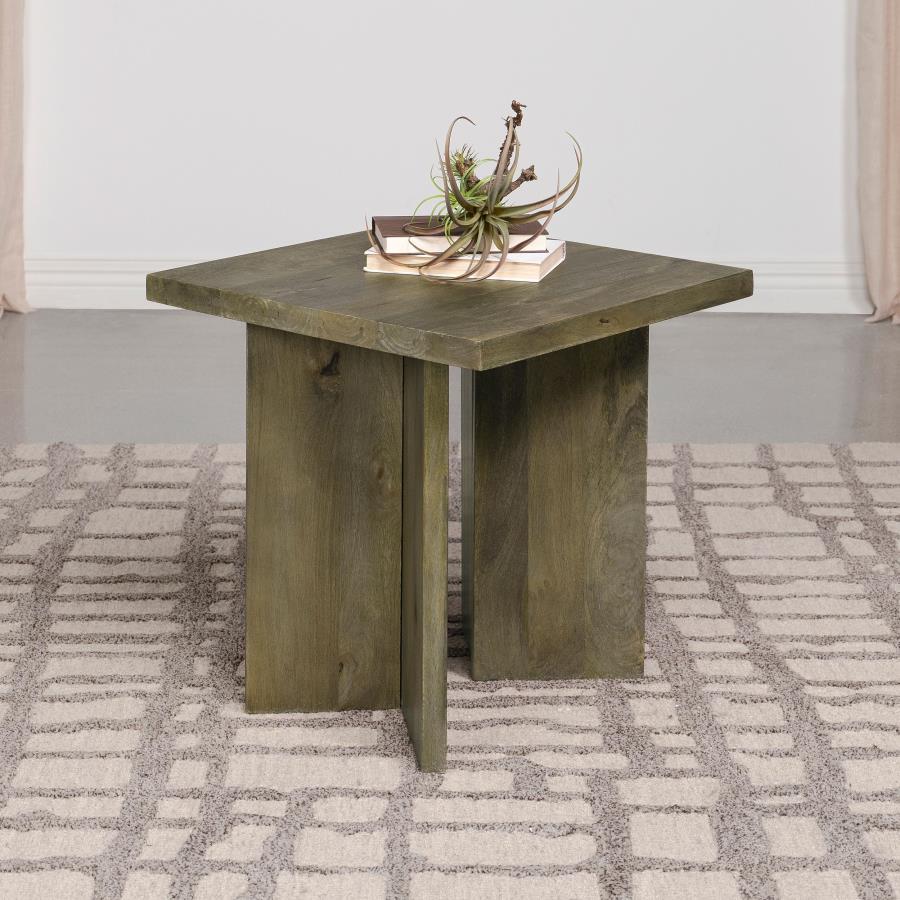 In the embrace of unadorned beauty, this end table stands with a rustic charm that echoes the soul of the wilderness. Solid mango wood, crafted from large and enduring planks, brings a touch of the untamed forest into the home. Its raw and robust design h