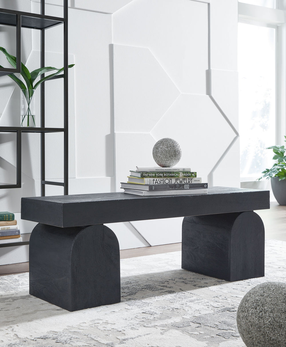 The solid craftsmanship and contemporary style of this bench make it the perfect accent piece in your modern living room, home office or entryway. Its lightly sandblasted effect exudes a decidedly on-trend vibe. Oversized decorative legs add an upscale ar