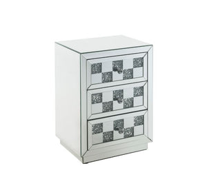 Bring life into your home with this dazzling Noralie Accent Table. With a glamorous mirrored finish, the table is accented by faux diamond inlays to impress all of your guests. The faux diamonds reflect a rainbow of colors throughout the room. The mirrore